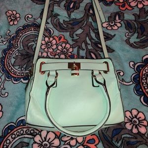 A Mint Green Handbag or Crossbody Purse.